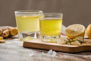 refreshing citrus lemonade,summer drink. Lemonade with fresh lemon on wooden background photo