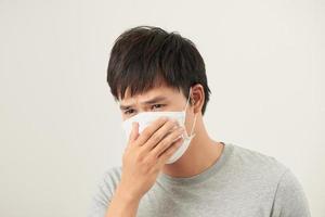 Asian man wearing a face mask with coughing photo