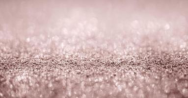 Abstract rose gold glitter sparkle texture with bokeh background photo