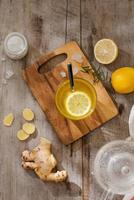refreshing citrus lemonade,summer drink. Lemonade with fresh lemon on wooden background photo