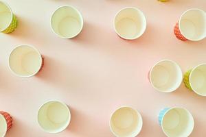 paper fashion cups on a delicate pink background photo