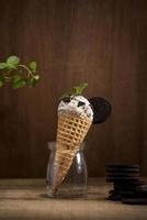 Sweet homemade ice cream with cookies in cone, selective focus photo