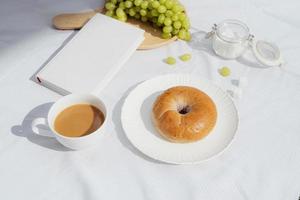 coffee, a good book and bread for a good morning in cafeteria photo