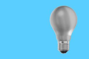 Realistic white light bulb. 3D rendering. Icon on blue background, text space. photo