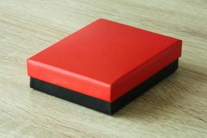 Mockup red and black box on wood table background photo