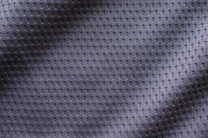 camiseta de fútbol de ropa deportiva de tela gris con fondo de textura de malla de aire foto