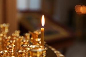 Orthodox Church. Christianity. Festive interior decoration with burning candles and icon in traditional Orthodox Church on Easter Eve or Christmas. Religion faith pray symbol. photo