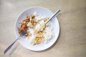 pollo geprek con arroz blanco tibio sobre fondo de madera foto