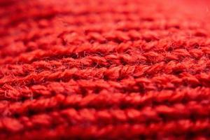 closeup red knitted woolen fabric texture background photo