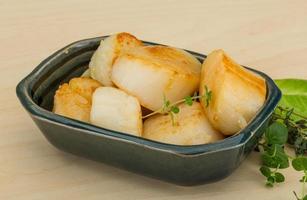 Grilled scallops in a bowl on wooden background photo