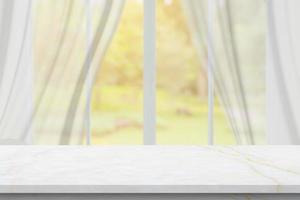 Marble table top on blur room interior with window curtain background photo