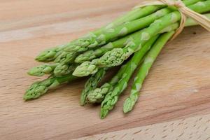 Asparagus on wooden board and wooden background photo