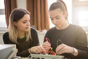 students doing practice in the electronic classroom photo