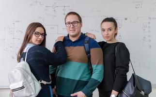 portrait of young students in front of chalkboard photo