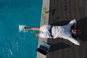 A modern senior man in casual clothes enjoys a vacation in an expensive house. Selective focus photo