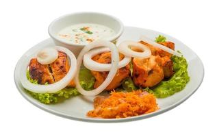 Chicken Tikka on the plate and white background photo