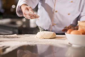 chef hands preparing dough for pizza photo