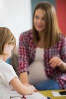 daughter painting nails to her pregnant mom photo