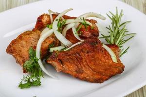 Shashlik on the plate and wooden background photo