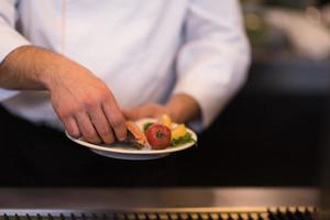 chef hands cooking grilled salmon fish photo