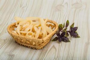 Dry calamari in a basket on wooden background photo