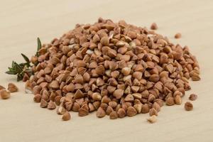 Raw buckwheat on wooden background photo