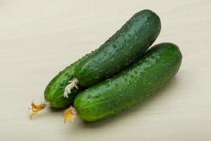 Cucumbers on wooden background photo