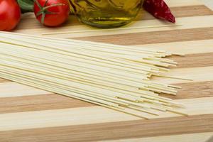 Egg spaghetti on wooden background photo