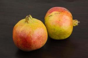 Yellow Pomegranet on wood photo