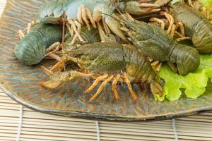 Raw Crayfish on wood photo