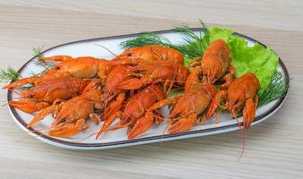 Boiled crayfish on wood photo