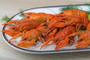 Boiled crayfish on wood photo