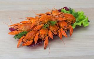 Boiled crayfish on wood photo