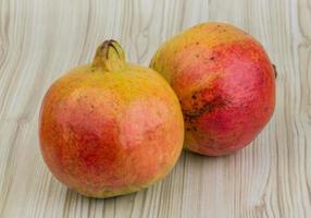 Yellow Pomegranate on wood photo