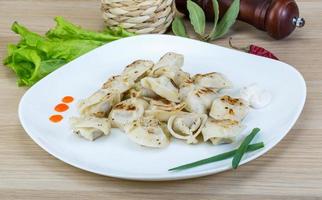 Roasted pierogi on wood photo