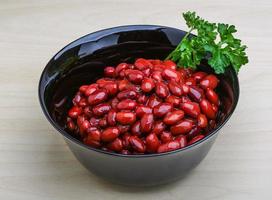 Baked beans in a bowl on wooden background photo