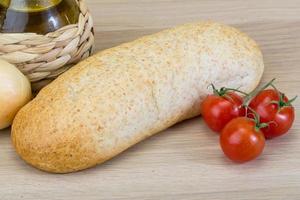 Fresh baguette on wood photo