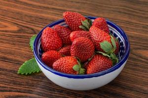 Fresh strawberry on wood photo