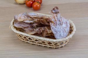 Dried squid on wood photo