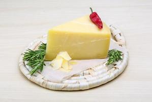 Parmesan cheese on wooden board and wooden background photo