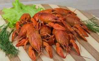 Boiled crayfish on wood photo