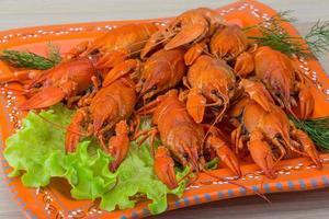 Boiled crayfish on wood photo