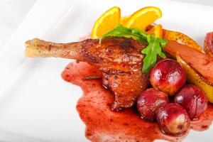 Duck leg on the plate and white background photo