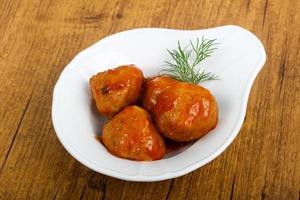 Meat balls in a bowl on wooden background photo