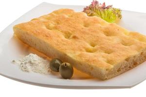 Olive bread on the plate and wooden background photo