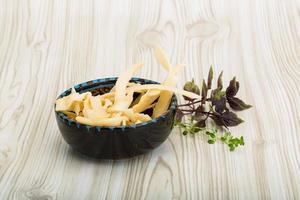 Dried squids in a bowl on wooden background photo