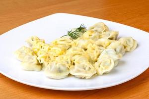 Russian dumplings on the plate and wooden background photo