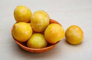 Yellow plums in a bowl photo