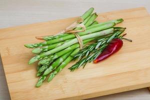 Raw asparagus on wood photo