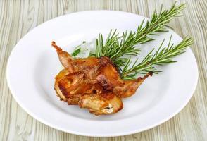 Grilled quail on wood photo